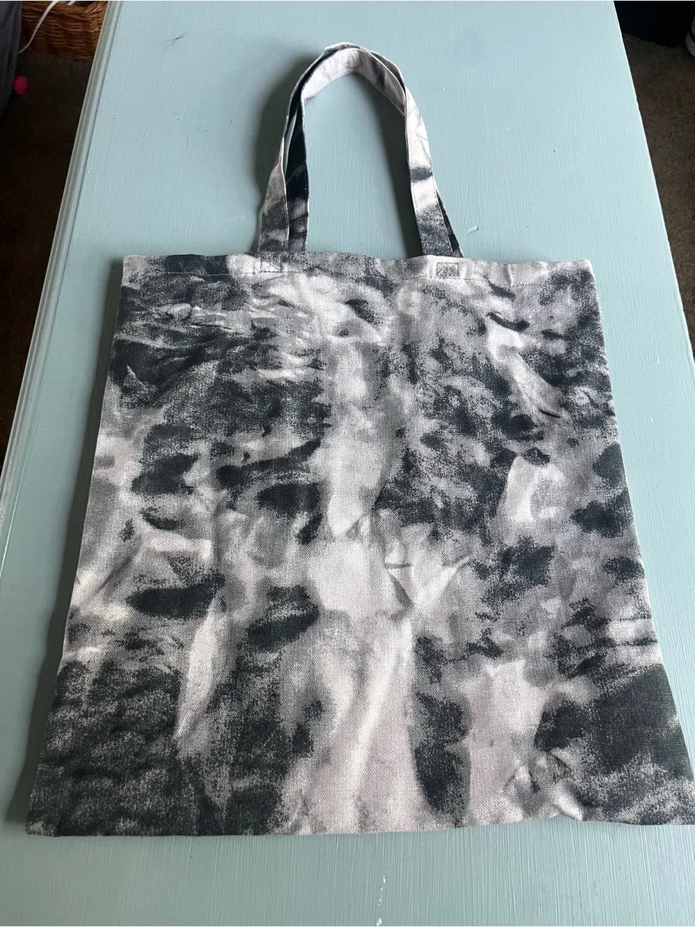 Medium tote bag black and white tie die “Strong than the Storm” on the bag